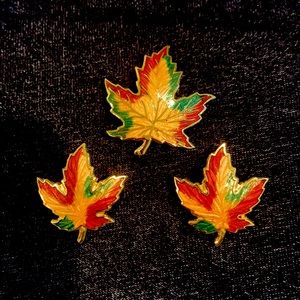 Set of three enameled Canadian maple leaf brooches